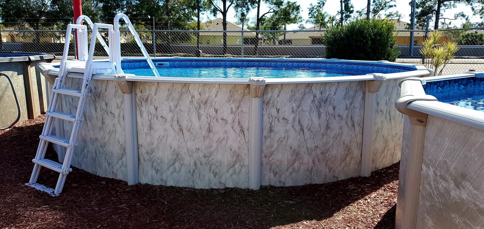 Above Ground Swimming Pools 11 An above ground pool in a customer's backyard at Mr. Pool Hudson location